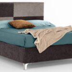 The Iris bed by Gienne Imbottiti is a double bed with a contemporary design, featuring a decorative headboard with geometric patterns and a fully upholstered structure.