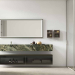 The composition N.34 from Arcom Design's Shape collection stands out for its use of natural materials paired with metallic finishes, aiming for a minimalist yet textural aesthetic.